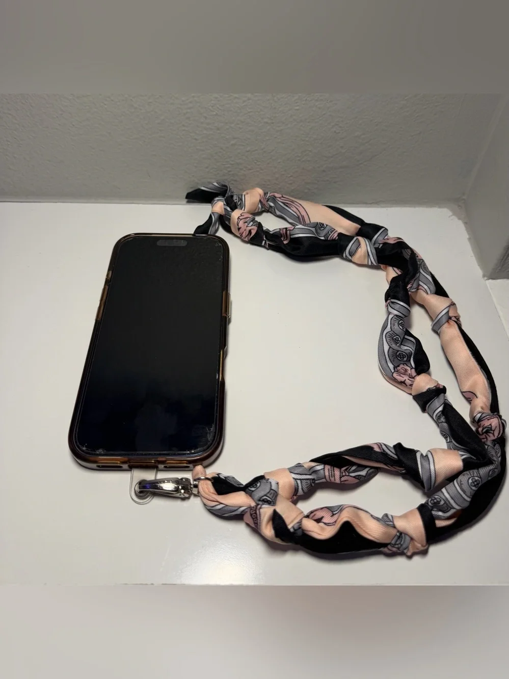 Silk-Twilly Pink and Black tied onto a leather lanyard holder/cell phone cord.